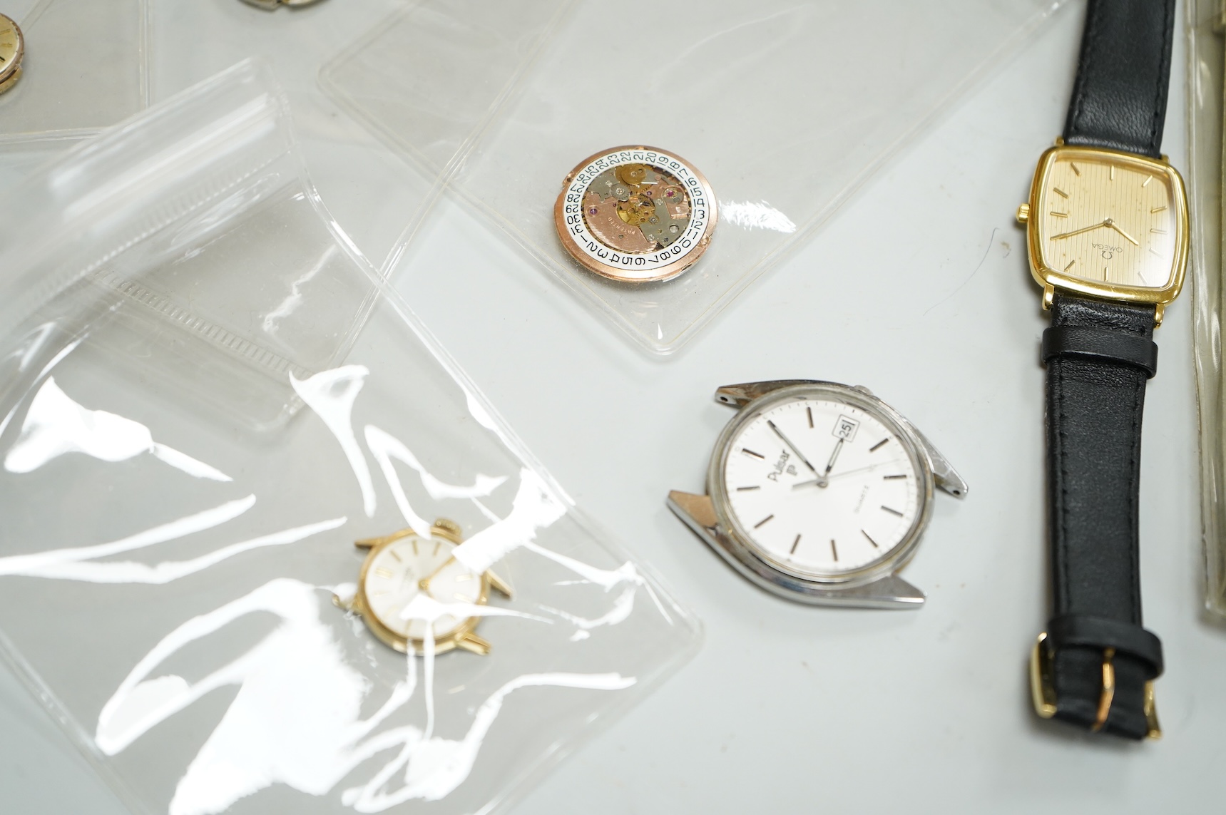 A small collection of assorted lady's and gentleman's wrist watches, including three Omega De Ville steel and gold plated quartz watches and wrist watches movements including Girard Perregaux.